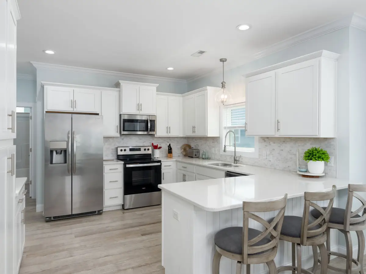 Spacious gourmet kitchen with island seating and modern appliances in Carolina Beach vacation rental.