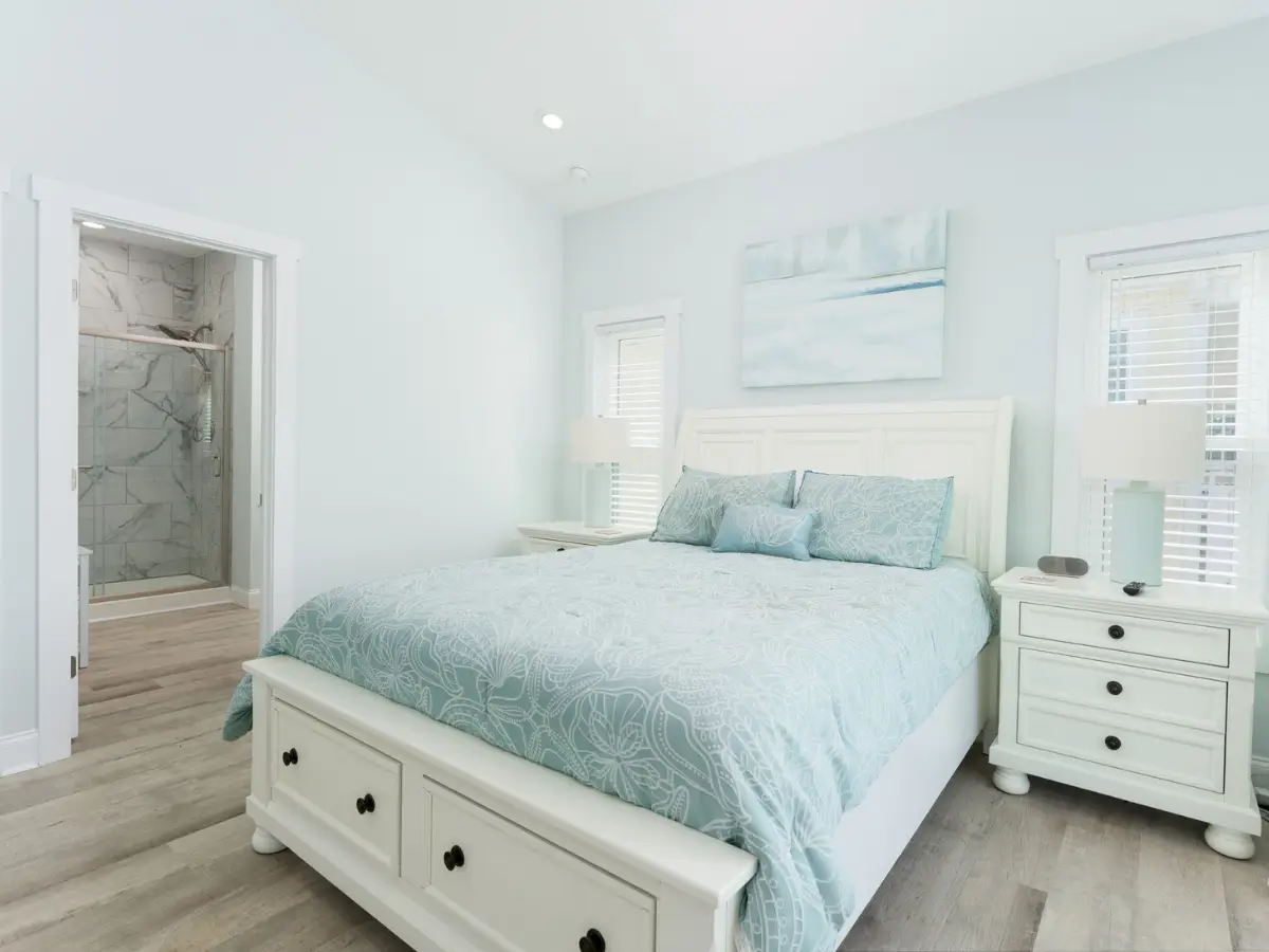 Spacious primary bedroom with king bed and private ensuite bathroom at A Sail Away vacation rental.