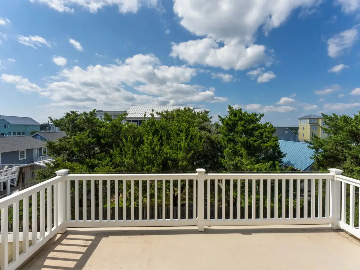 Private rooftop deck with elevated views of Ocean Isle Beach and surrounding coastal neighborhood.
