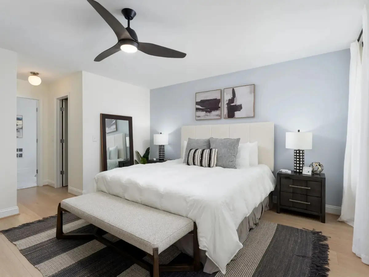 Spacious primary bedroom with king bed, modern furnishings, and calming coastal décor.