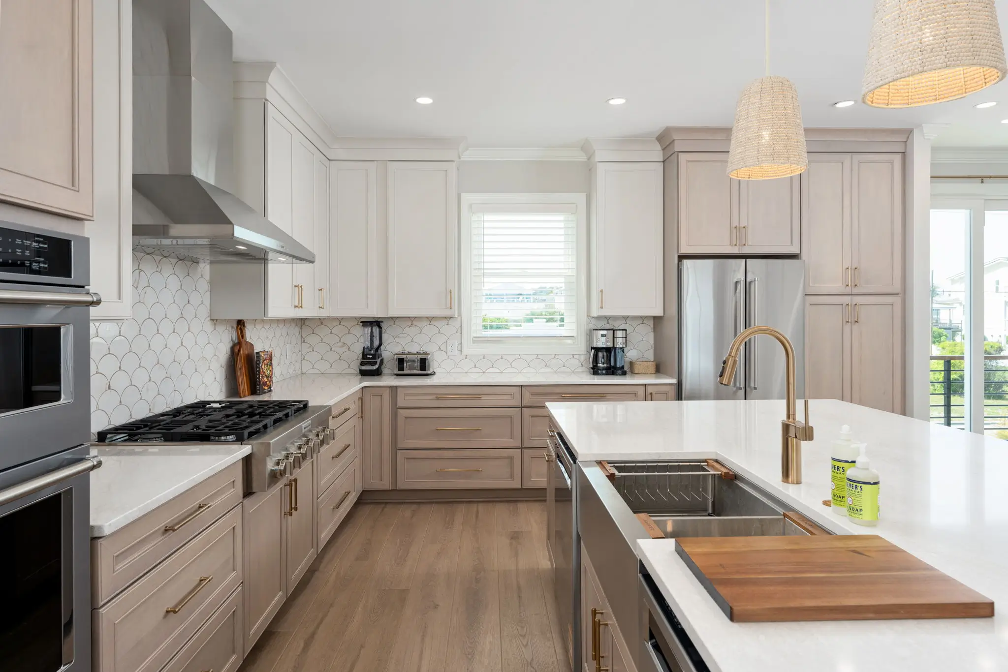 Luxury coastal kitchen with large island and stainless steel appliances