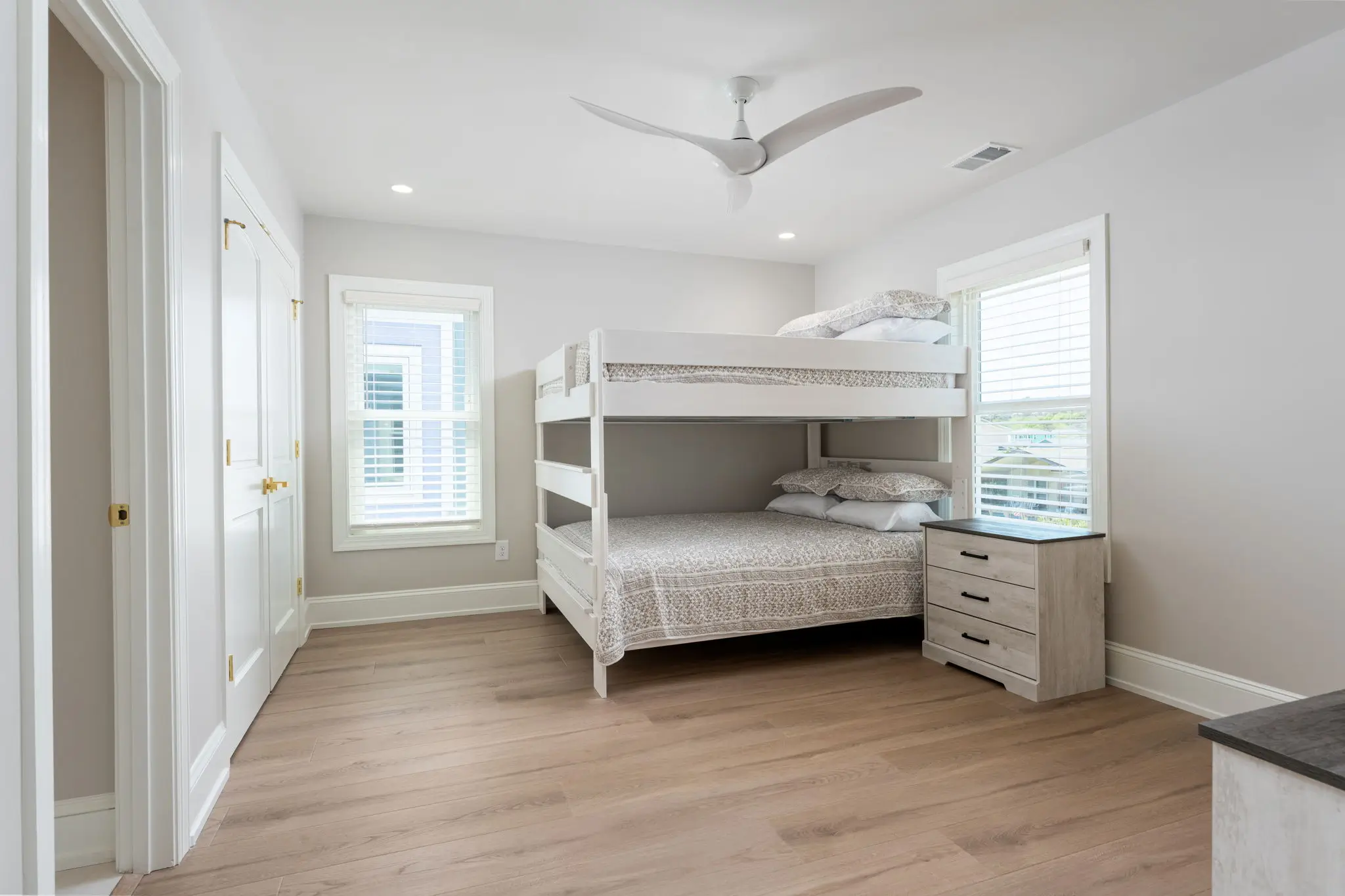 Guest bedroom with double queen bunk beds at The Pearl in Kure Beach