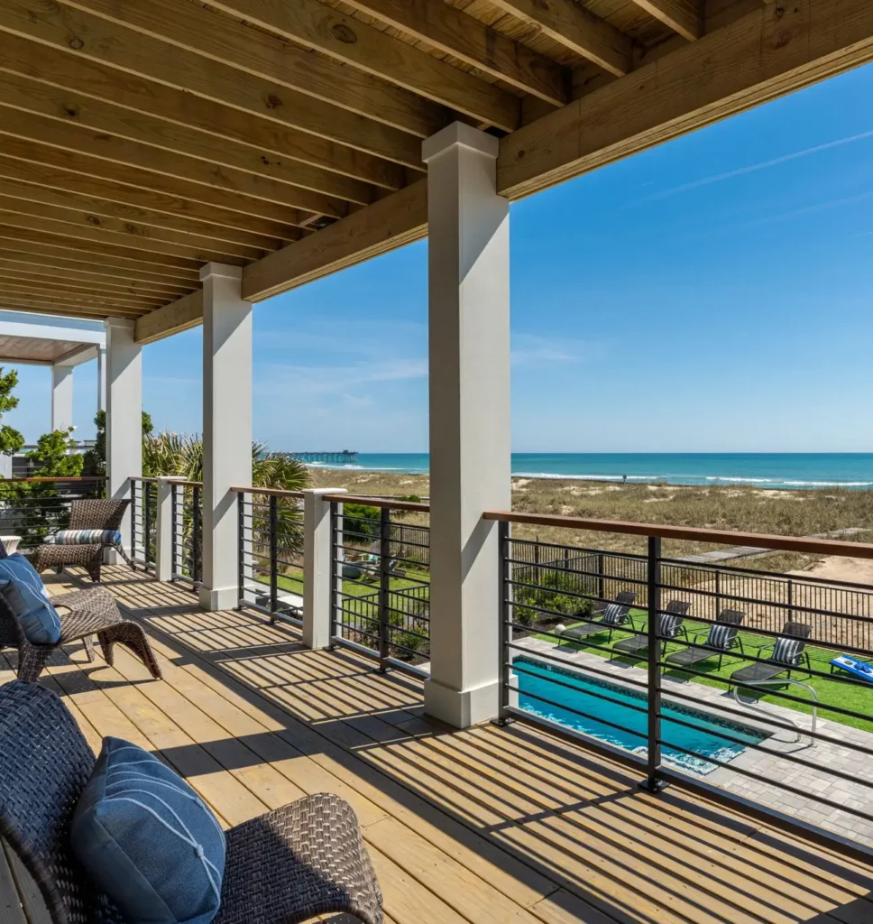 Covered oceanfront deck overlooking the beach and private pool at The Pearl