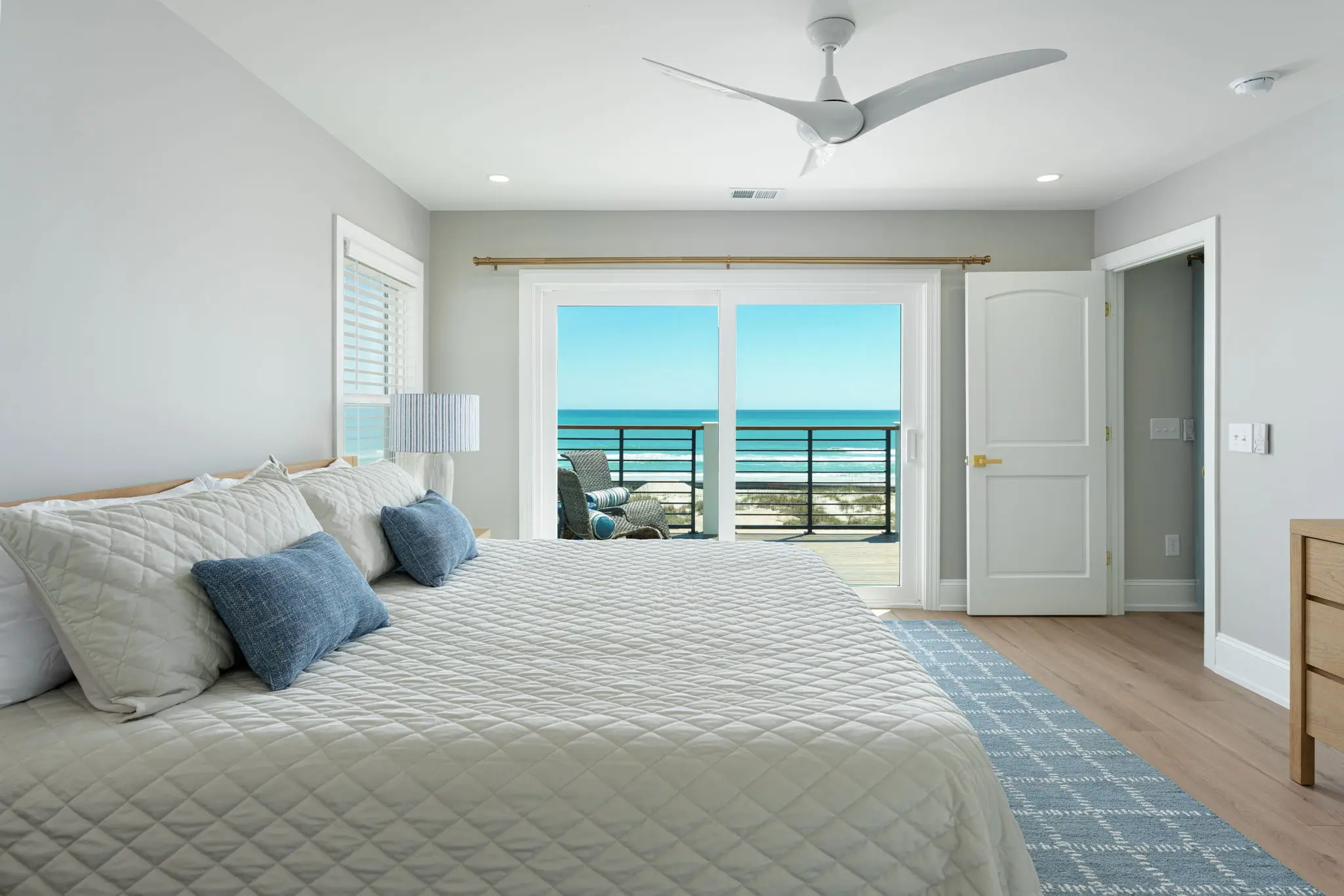 Ocean-view guest bedroom with deck access at The Pearl vacation rental