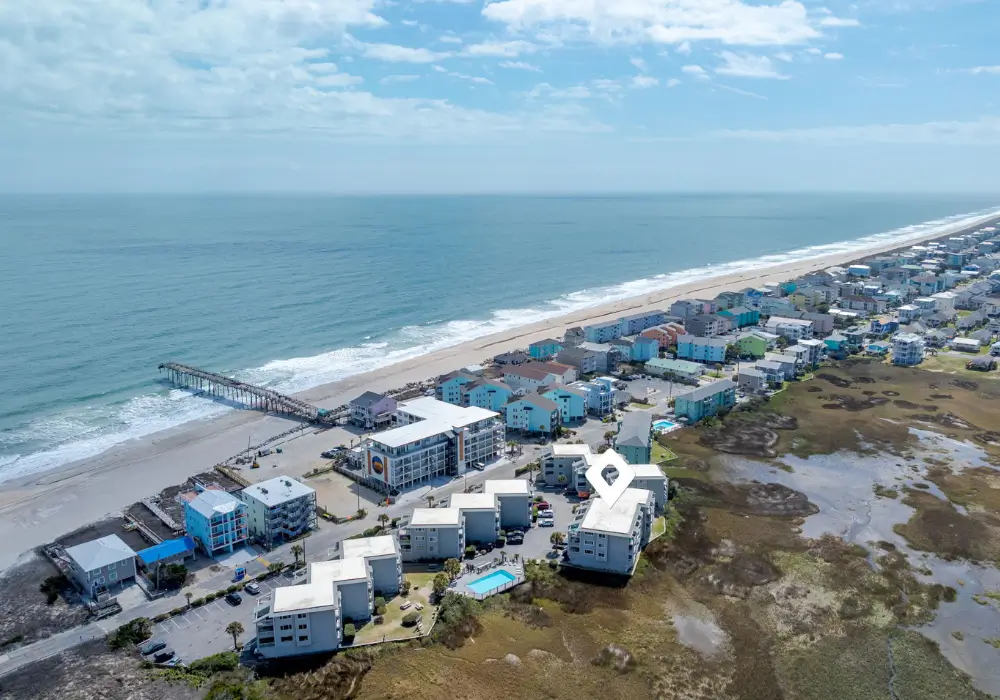 Aerial view showing The Sunshine Shack near the beach and Carolina Beach Pier