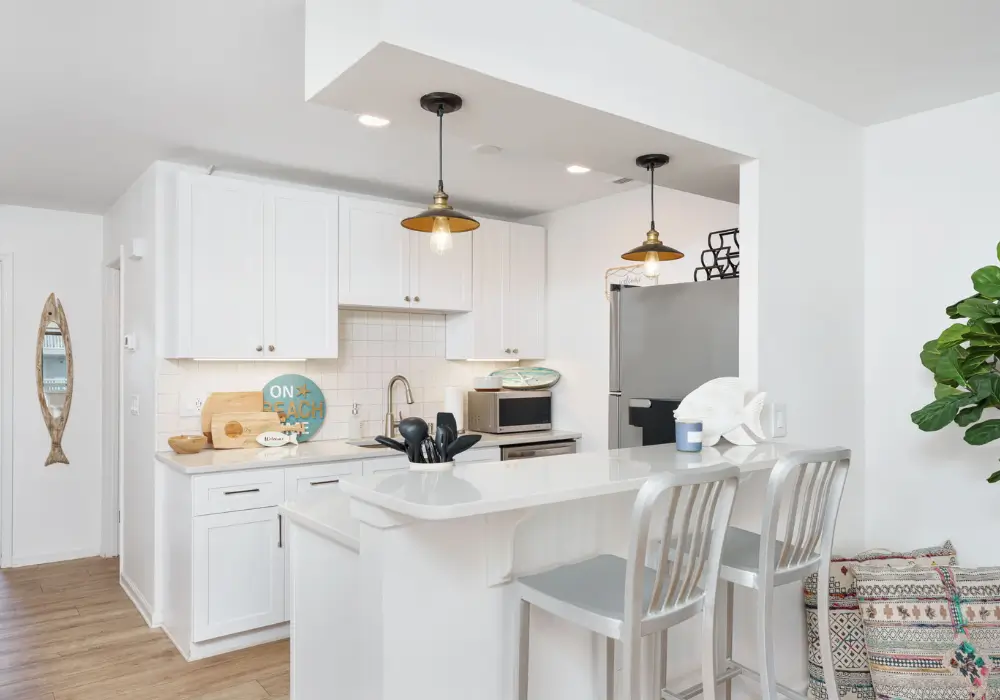 Bright kitchen with breakfast bar seating at The Sunshine Shack