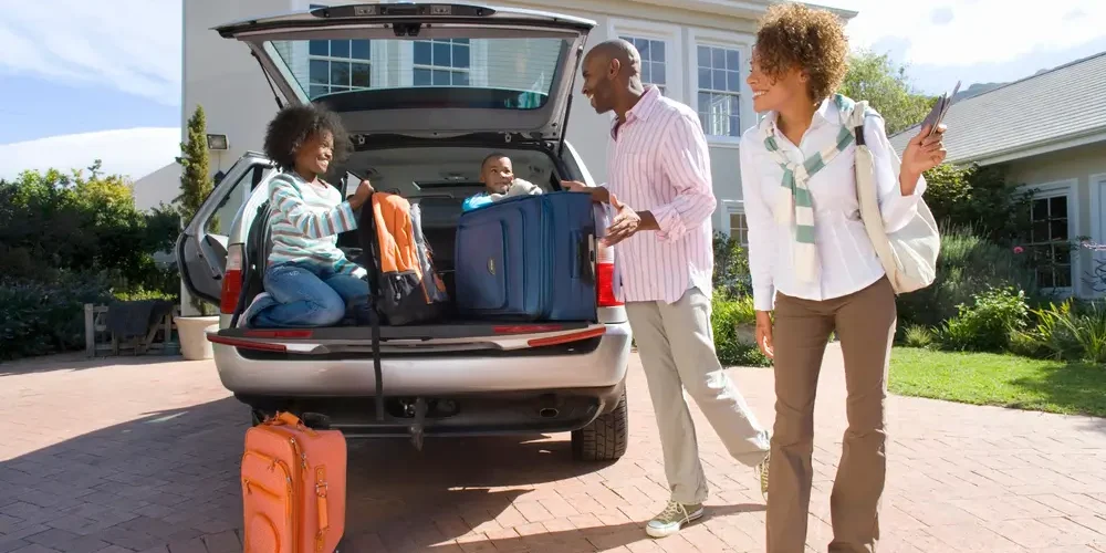 Property manager welcoming tenants outside a professionally managed rental home.